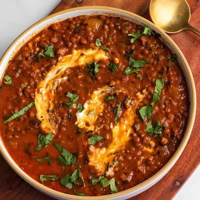 Roasted red peppers blend seamlessly with rich coconut milk in this dal dish, creating a velvety sauce that envelops the hearty brown lentils. 