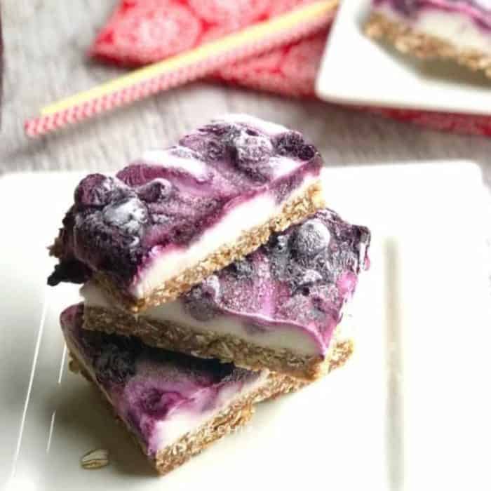 Healthy frozen yogurt oat bars with a blueberry swirl give you the hearty wholesomeness of an oat base with dates and the creamy tang of yogurt, all elevated by a vibrant blueberry swirl.