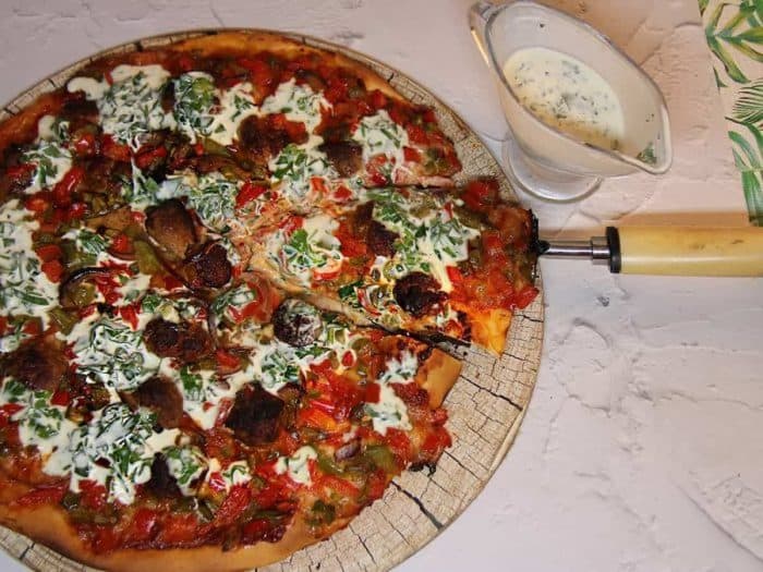 homemade sausage and pepper pizza a symphony of flavors with a creamy garlic twist