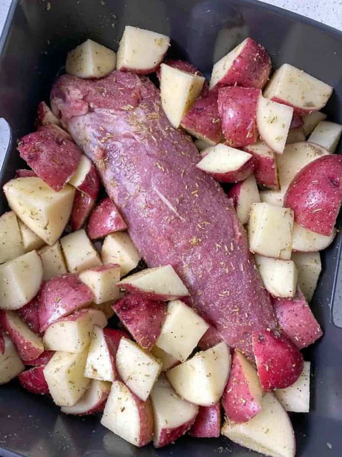 arrange the tenderloin in the air fryer, and nestle the seasoned potatoes around it.
