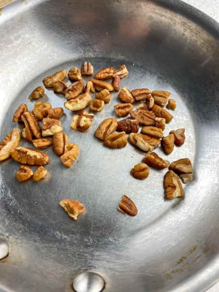 Add chopped pecans to a skillet over medium heat.