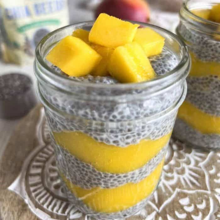 mango chia pudding with mango on top on a jar