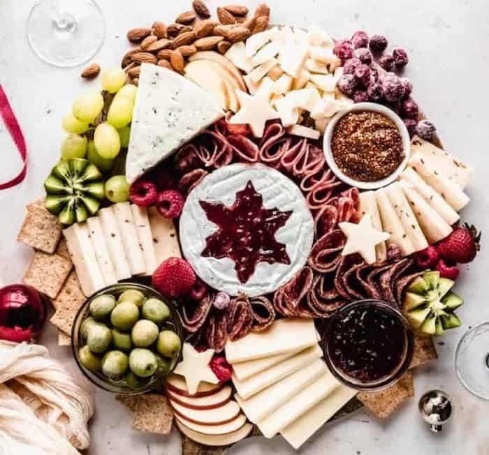 This charcuterie board is a feast for the senses with soft and hard cheeses, fresh fruits, assorted deli meats, crunchy nuts and crackers, and delicious dips.