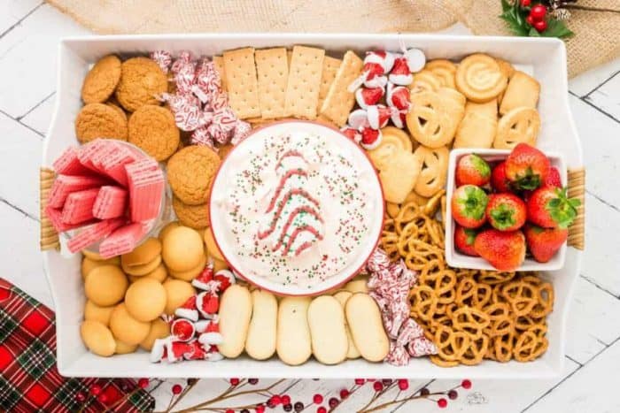 christmas tree cake dip dessert boasts a rich, creamy dip made with cream cheese and Cool Whip, along with an assortment of dippable treats, like cookies, pretzels, wafers, and strawberries