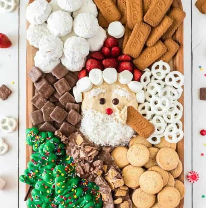 This Christmas cookie charcuterie board idea is a jolly spread that features assorted cookies, pretzels, and graham squares.