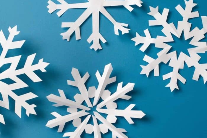 Challenge your kids to cut out snowflakes from white construction paper for a fun and advanced crafting activity. They can experiment with different cuts and patterns to create unique designs they can proudly call their own.