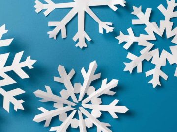 Challenge your kids to cut out snowflakes from white construction paper for a fun and advanced crafting activity. They can experiment with different cuts and patterns to create unique designs they can proudly call their own. 