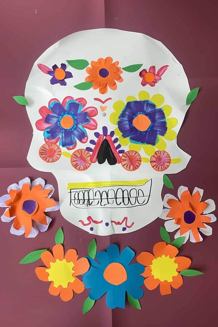 Encourage them to create Day of the Dead construction paper skulls and decorate them with painted flowers and swirls. 