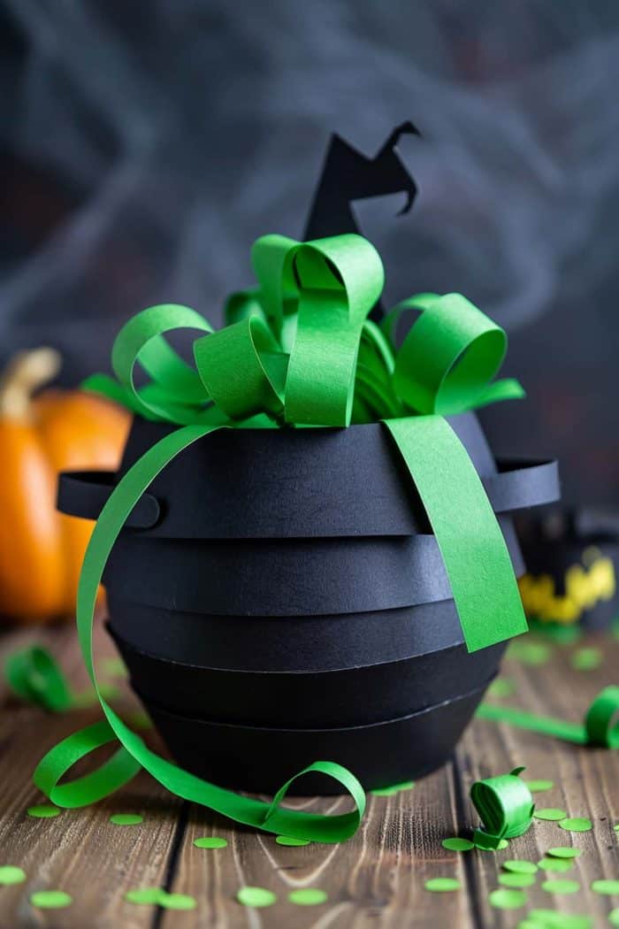 This bubbling cauldron features green paper "mist" emanating from it, which symbolizes witches’ brewing potion. 
