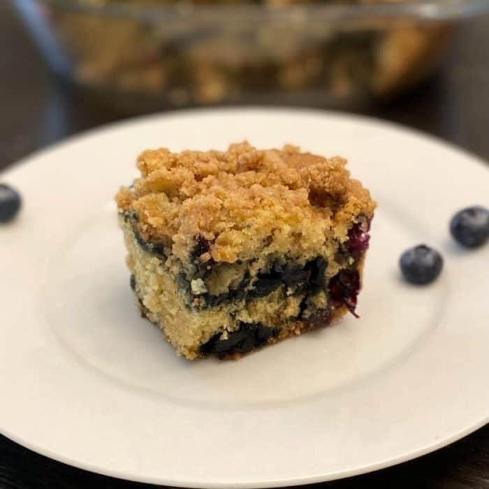 This vegan berry crumb cake boasts a wonderful tapestry of flavors and textures, featuring a soft cake that bursts with fresh berries and comes with a buttery crumb topping.