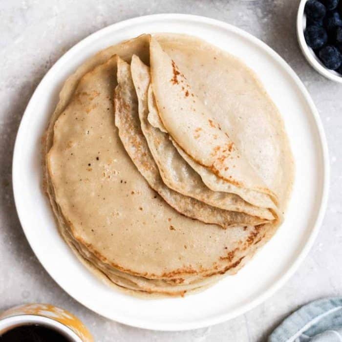 a plate of crepe made with any plant-based milk or any type of sugar, and they can be filled with sweet or savory toppings.