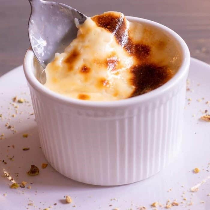 This eggless pudding is traditionally served chilled, with a sprinkle of cinnamon on top for a hint of warmth and spice.
