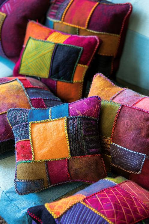 Assemble patchwork throw pillows using squares of felt in different colors and patterns, stitched together to form a vibrant mosaic. 