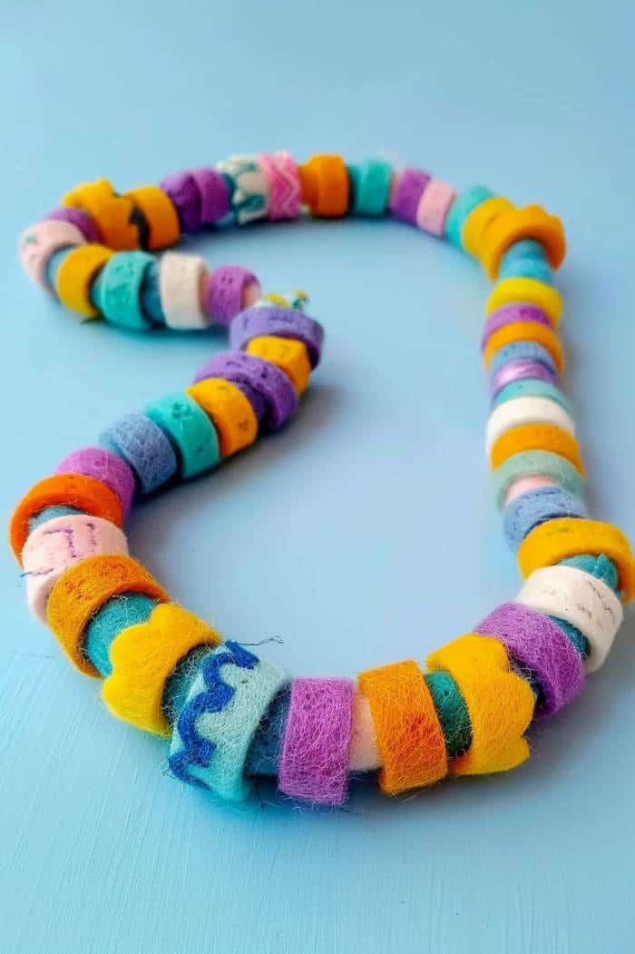 The felt texture and varied colors add unique visual interest to the necklace, which can match and enhance different outfits.