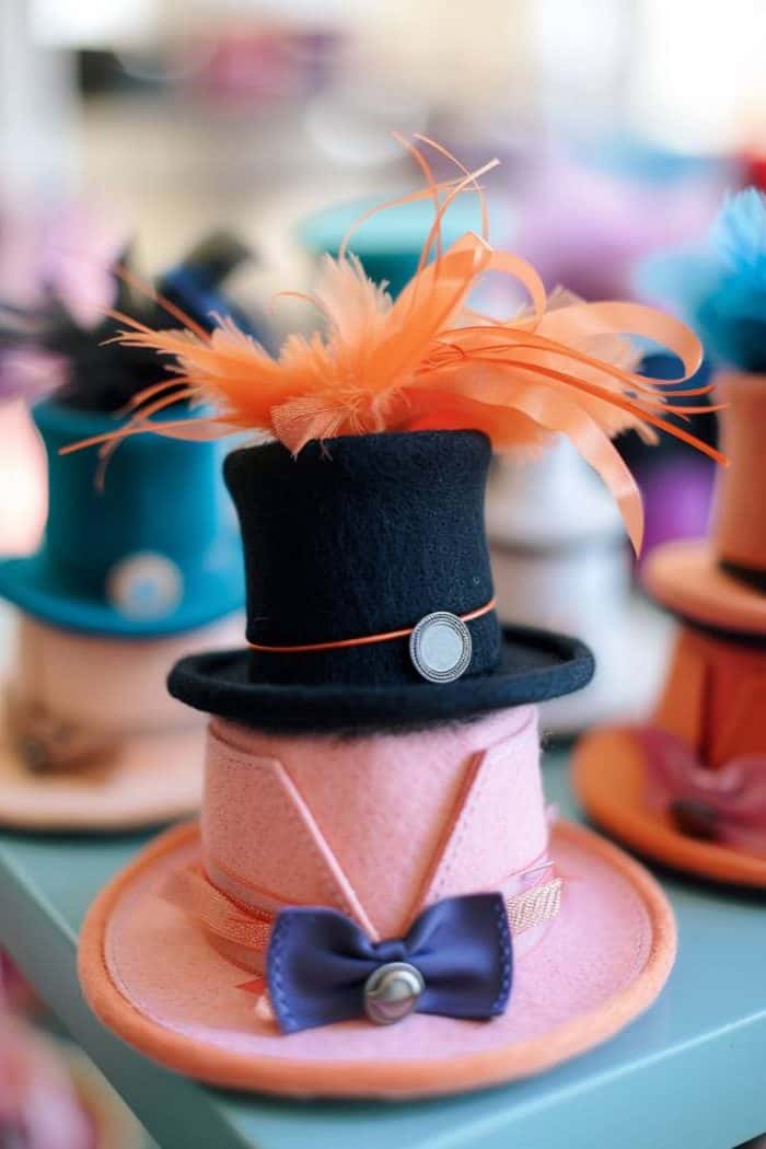 Assemble top-hat party favors from stiffened felt, cutting and shaping it into miniature top hats. 