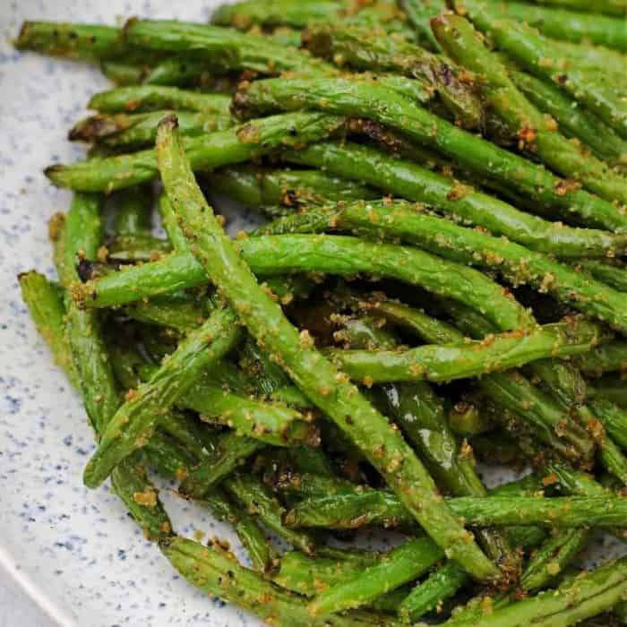 A sumptuous blend of melted butter and a robust garlic and herb seasoning enhances their natural flavor, while the air fryer gives them a delectable crunch and brings out their tantalizing green hue.