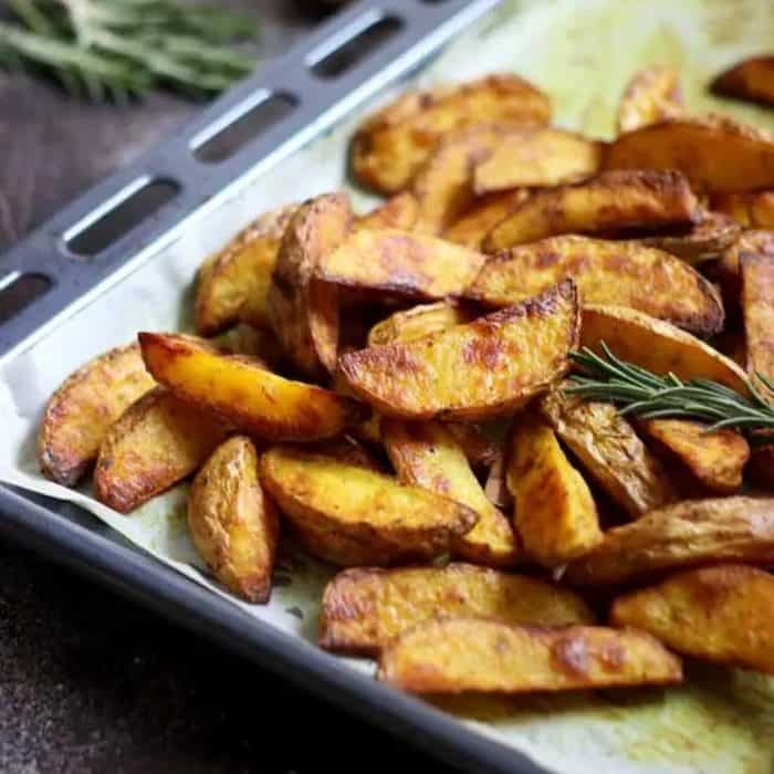 These baked potato wedges emerge from the oven with a golden crust and a pillow-soft interior generously sprinkled with herbs and seasonings that tantalize the taste buds.