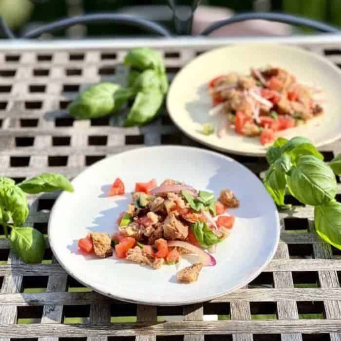 This classic recipe showcases a mix of juicy tomatoes, crisp cucumbers, and sharp red onions, all placed among stale chunks of bread that soak up the vibrant dressing.