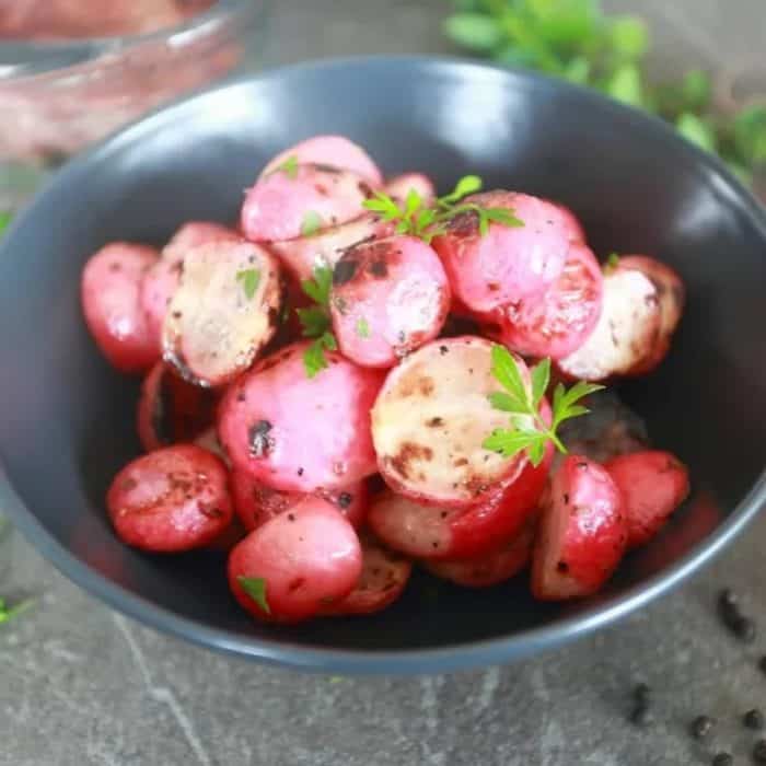 Grilling radishes tames their peppery bite and enhances their natural sweetness, resulting in a softer, smokier bite that goes perfectly with a grilled steak.