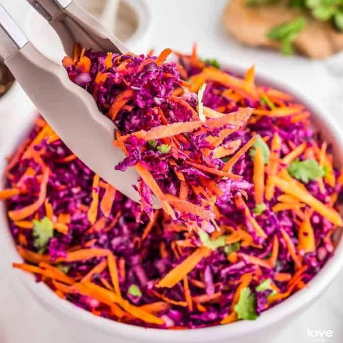 With ribbons of crunchy red cabbage and carrots dressed in a sweet, acidic vinaigrette, this slaw can bring a splash of color and freshness to any steak cut.