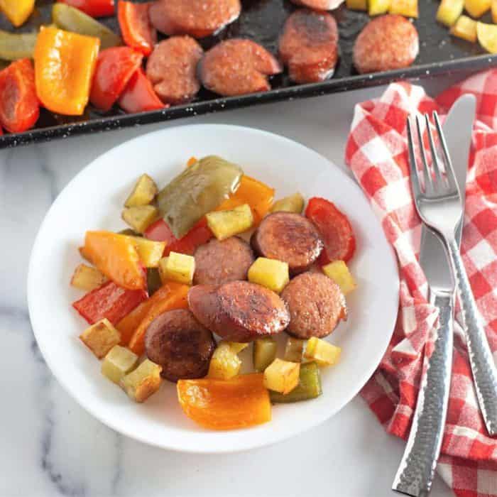 kielbasa on a sheet pan with potatoes and peppers for a quick and delicious dinner option