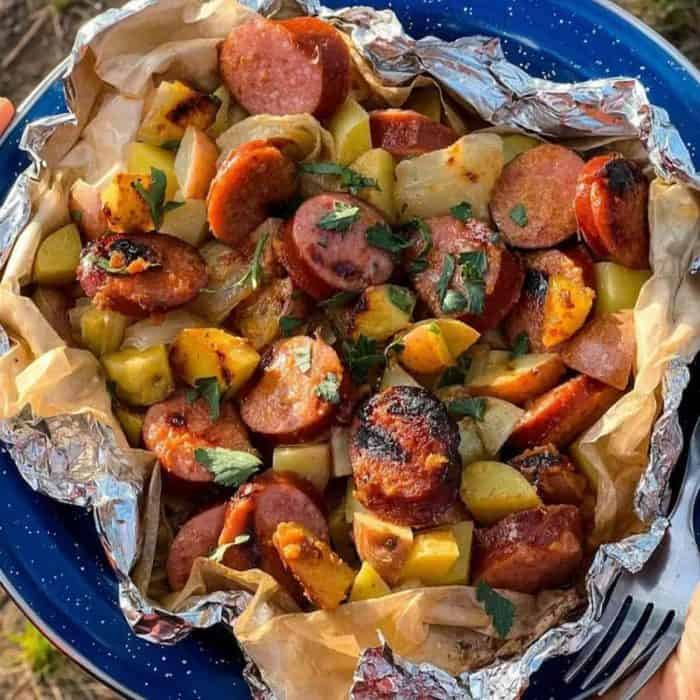combine kielbasa, potatoes, and onions with a honey mustard sauce in a foil packet and grill it to perfection