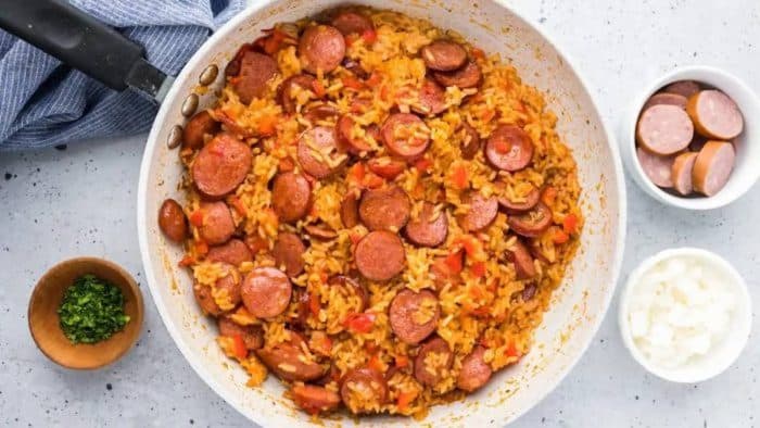 This super quick and easy recipe is simply a one-pot sausage and rice dish that’s packed with savory, smoky sausage flavor, tender diced peppers, and flavorful tomato rice.