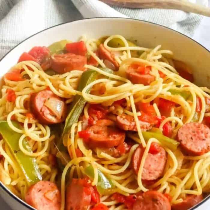 a bowl of freshly cooked his kielbasa and pepper pasta with tomatoes