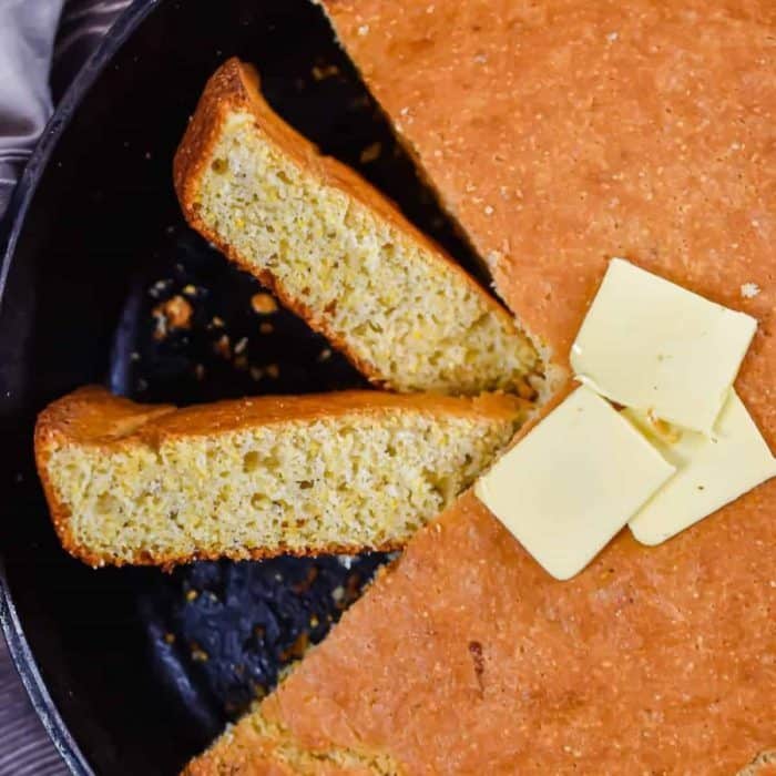 close up image of Sourdough Discard Cornbread topped with butter