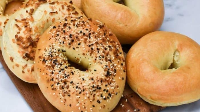 freshly baked New York-style bagels by using sourdough discard with different toppings