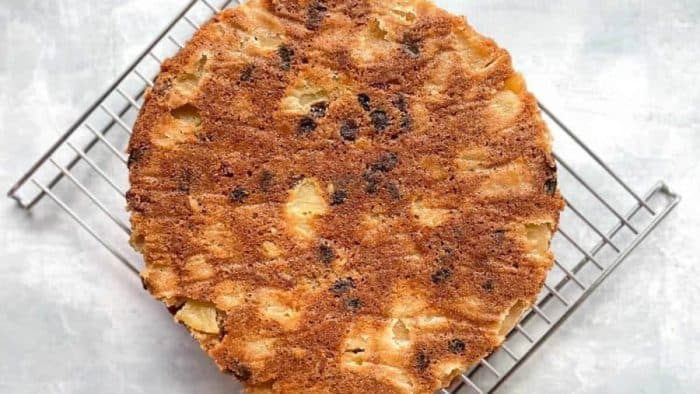 The Sourdough Apple Cake is richly aromatic, moist, and filled with a dense assortment of apples, pecans, and raisins.