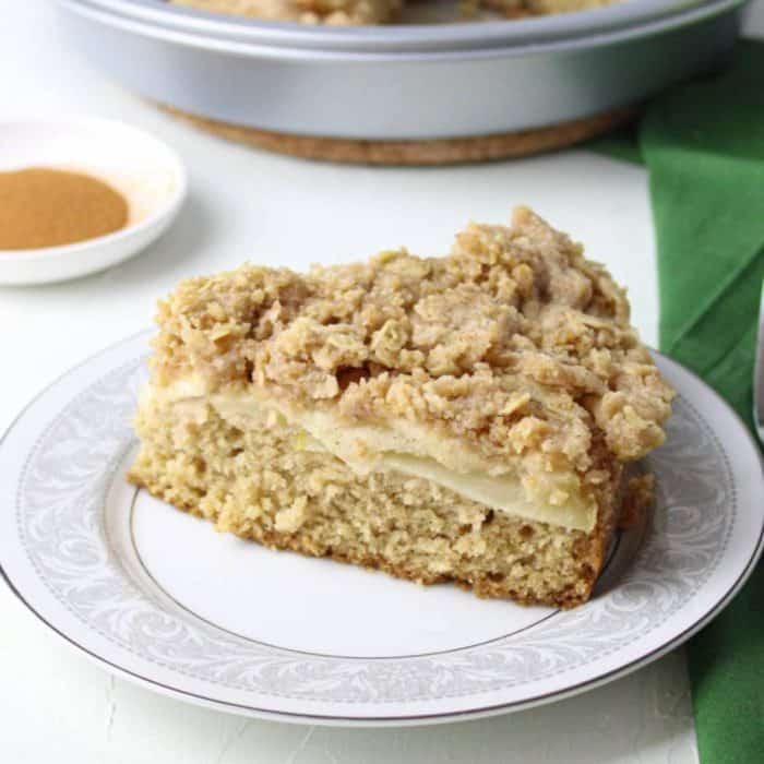 Layers of a fluffy, cinnamon-infused cake, baked apple slices, and a crumbly streusel come together to create this rustic and homey dessert, which is a vegan take on the traditional Irish apple cake. 
