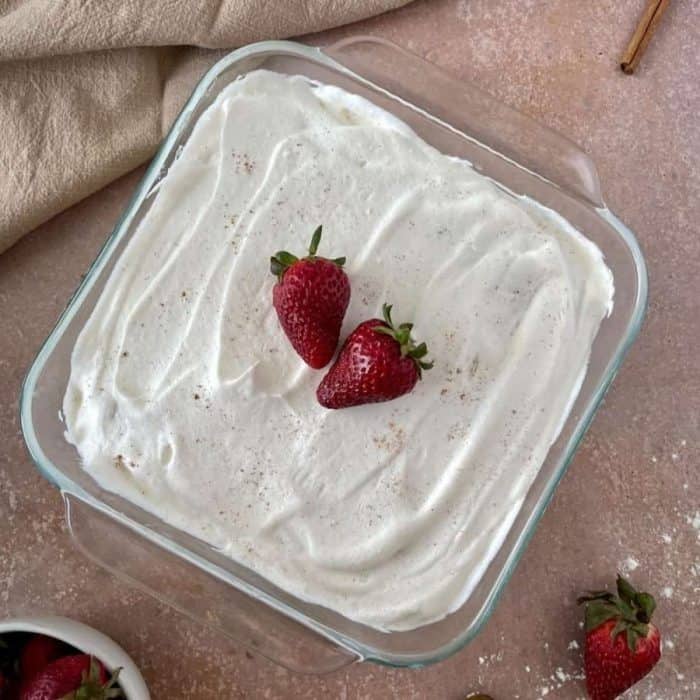 Tender and light, the sponge cake here eagerly soaks up a trio of sweet plant-based milk, transforming into a luscious delight that's crowned with a pillowy layer of dairy-free whipped cream and fresh berries. 