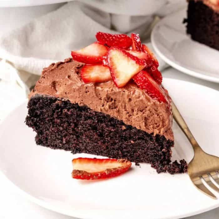 The cake's base is a rich, fudgy cake layer topped with a light, airy chocolate mousse made from melted dark chocolate and water. Topped with strawberries, it brings together fruity and chocolatey flavors for the ultimate sweet treat. 