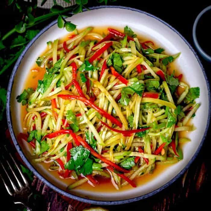 Shredded cucumbers and bell peppers are paired with chopped coriander and bathed in a delicious dressing made with soy sauce, sesame oil, sugar, and lemon juice — the perfect choice to offset rich flavors.