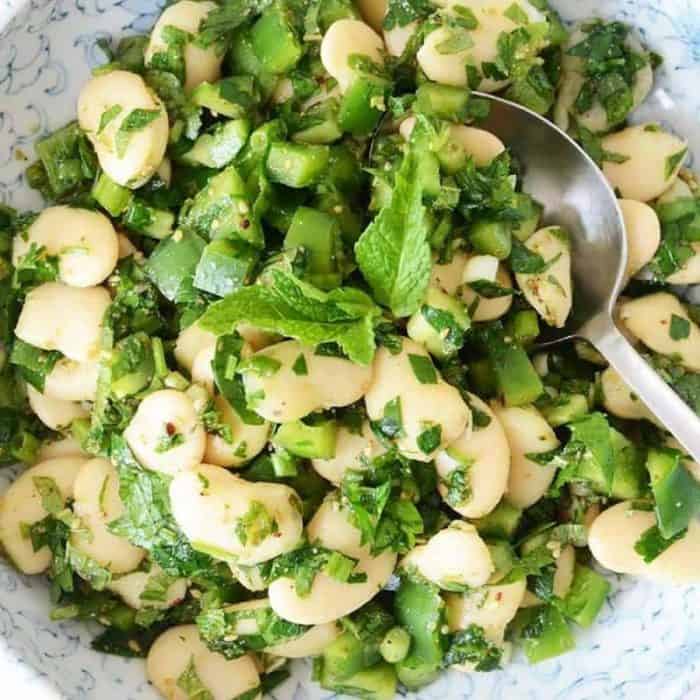 The hearty texture of butter beans is amped up by green bell peppers in this recipe, and both ingredients are tossed in a lemon, olive oil, and za’atar dressing and garnished with cool mint.