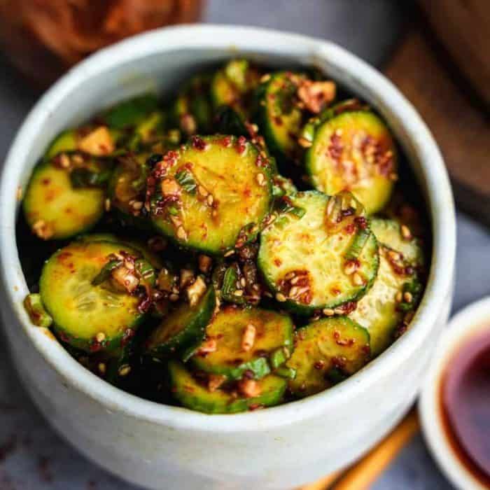 Crisp cucumber slices are elevated with a spicy kick in this Korean cucumber salad (Oi Muchim), where gochugaru, rice vinegar, garlic, and sesame oil tantalize the palate.