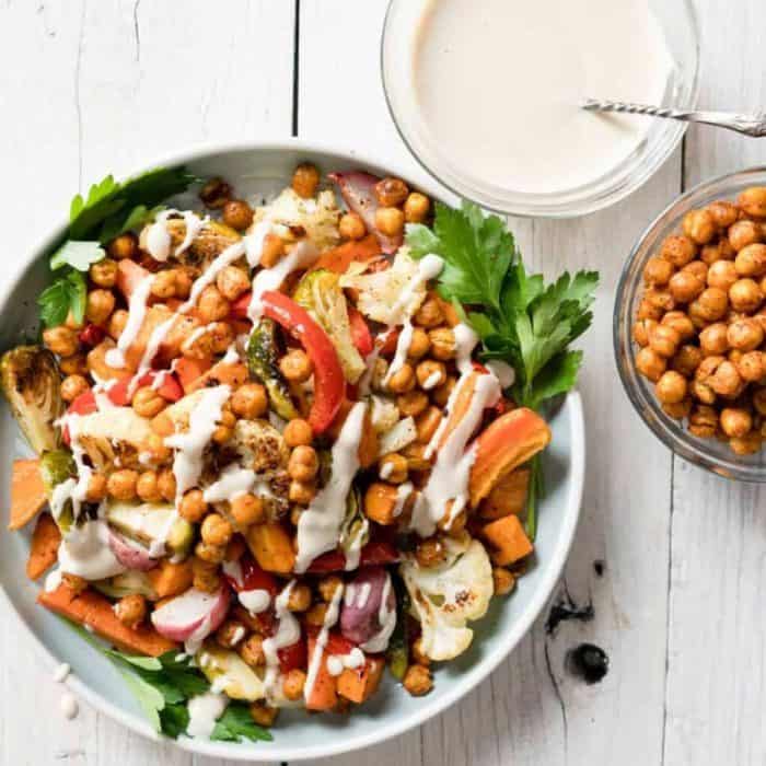 Warm, roasted vegetables like carrots, bell peppers, and cauliflower florets mingle with perfectly spiced chickpeas in the roasted vegetable salad, where warmth and comfort are served with a generous helping of healthful indulgence.