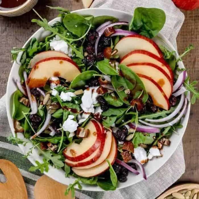 Indulge in the delightful crunch of this salad, which highlights the freshness of crisp Fuji apples and the subtle sweetness of dried cranberries. Vegan feta cheese and slivers of red onion also add creamy contrast and a sharp bite to the ensemble.