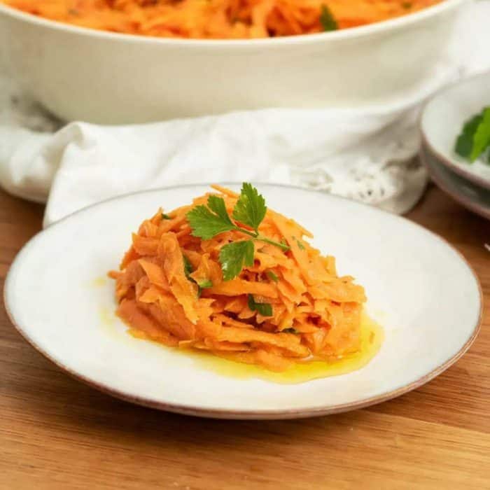 It boasts a sweet and bright duo of grated carrots and a traditional vinaigrette. Chopped parsley sprinkled atop adds a burst of color and a herby freshness, making it a great side that's super easy to make.