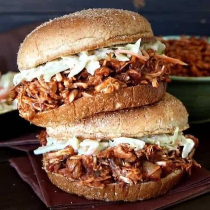 a photo of a pulled jackfruit bbq sandwich sandwich on a wooden chopping board