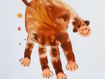 Create a playful handprint monkey by painting your child's hand with brown paint and pressing it onto paper to form the monkey's body and legs. Once dry, add a face, ears, and a long tail using a brush or additional handprints.
