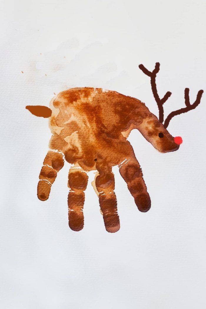 Create an adorable handprint deer by painting your child's hand brown and pressing it onto paper to form the deer's body and legs. 