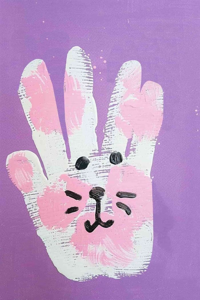 Use handprints with the fingers together and thumbs out for bunny ears to create Easter bunnies. 