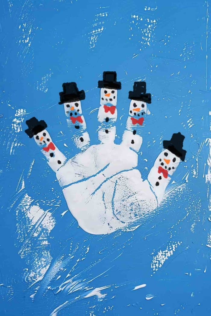 Create a festive snowman handprint painting by painting your child's hand white, pressing it onto blue-colored paper, and painting snowman details. A truly fun craft that you can also display as Christmas decor!