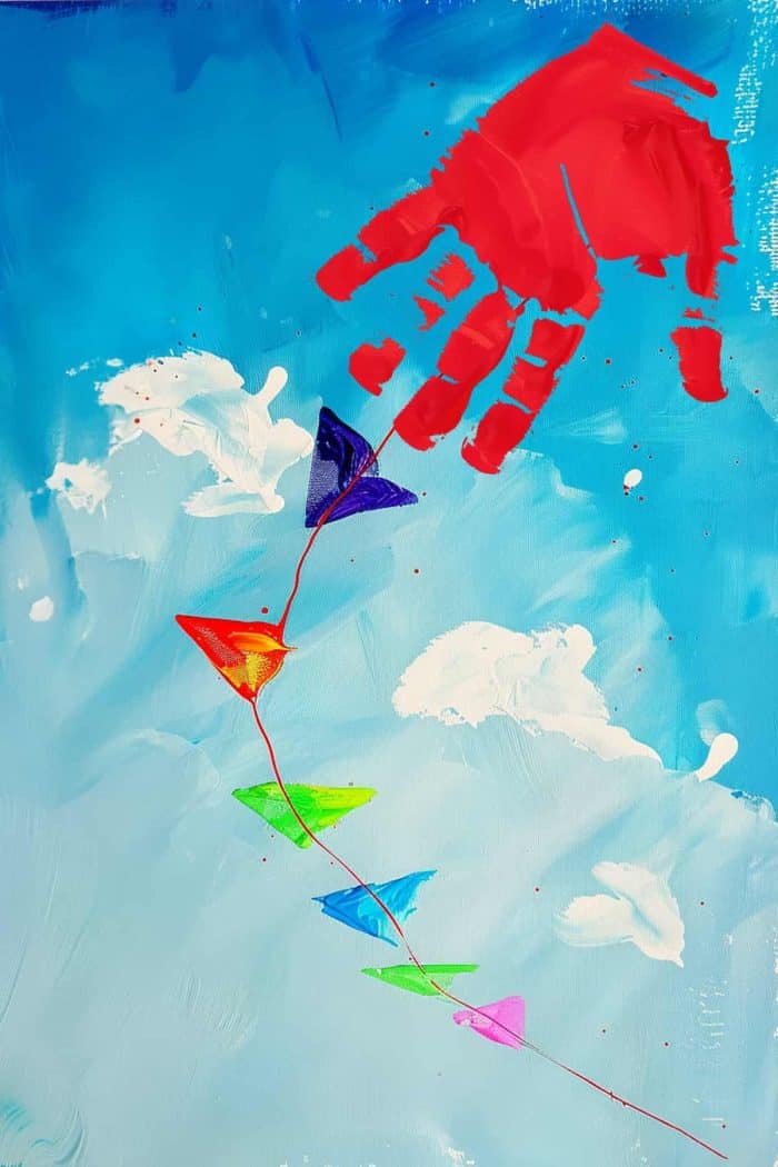 Use an upside-down handprint in a bright red color to create a unique kite. Position the kite on a sky blue background and create a colorful tail to capture the joy of a kite soaring on a breezy day.