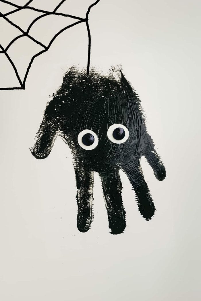 To make these spooky handprint spiders, paint your child's hands black and press them onto paper with fingers spread wide to form the legs. 