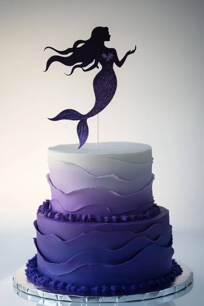 There’s a mysterious allure to this cake, with a mermaid silhouette cake topper above a beautiful purple ombré cake. To create this look, use an airbrush for the gradient effect. You can also get a glittery mermaid silhouette for a hint of sparkle.