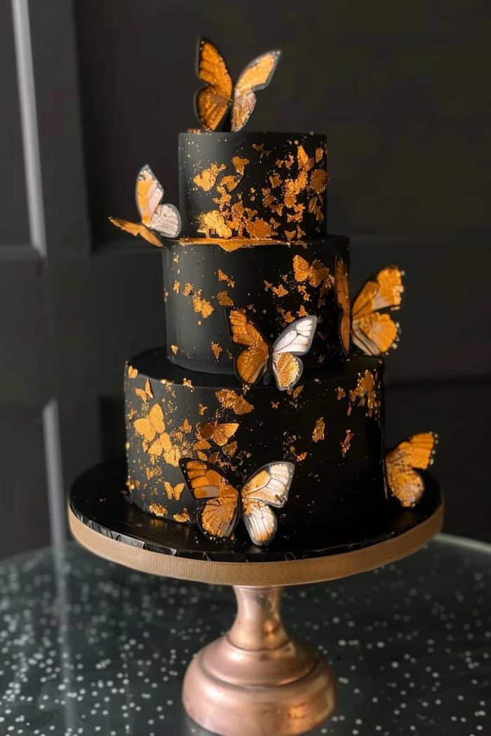 For a truly luxurious cake, adorn a dark-colored base with gold leaf accents and butterflies. 