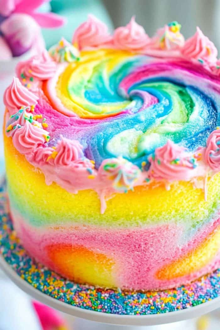 Inject some fun and color into your baking with a rainbow tie-dye cake featuring a mesmerizing swirling pattern.